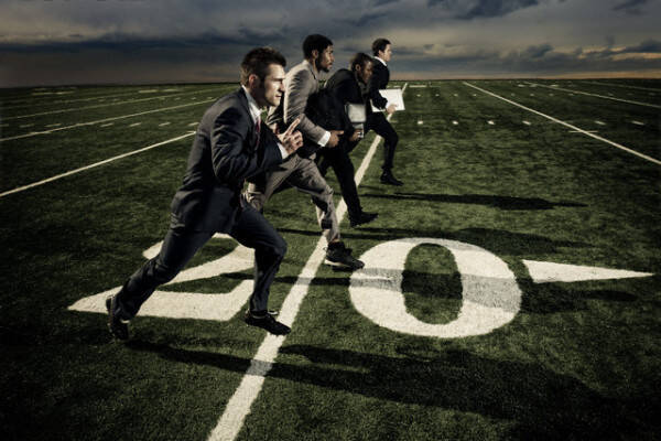 Businessmen Running on Football Field